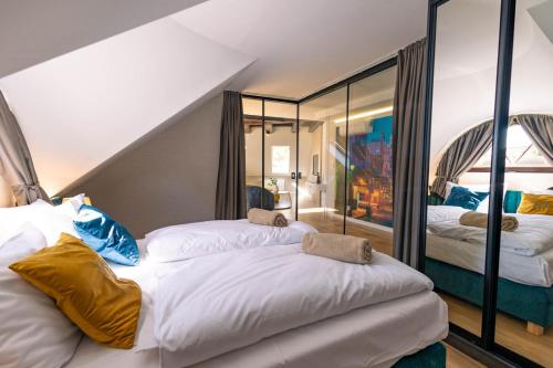 a bedroom with two beds and a staircase at Boulevard Boutique Suites in Łeba