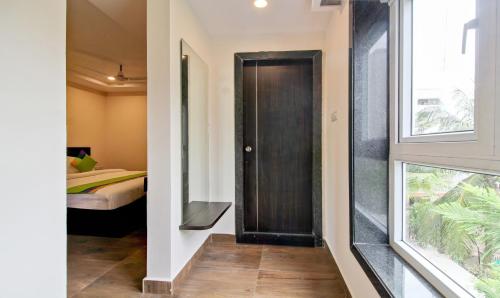 a hallway with a door leading to a bedroom at Treebo Excella in Visakhapatnam