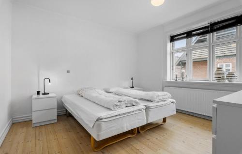 Stunning Home In Fjerritslev With Wifi في Fjerritslev: غرفة نوم بيضاء بها سرير ونافذة