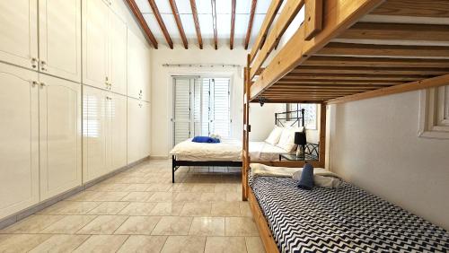 a bedroom with two bunk beds in a room at Kings Bungalow in Paphos