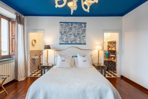 a bedroom with a large white bed with two pillows at Maison Fernanda in SantʼAgata sui Due Golfi