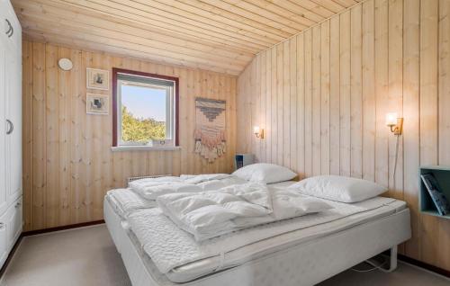 a bedroom with a bed in a wooden wall at Beautiful Home In Tarm With Wifi in Tarm