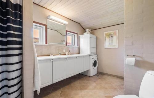 a bathroom with a sink and a washer and dryer at Beautiful Home In Tarm With Wifi in Tarm