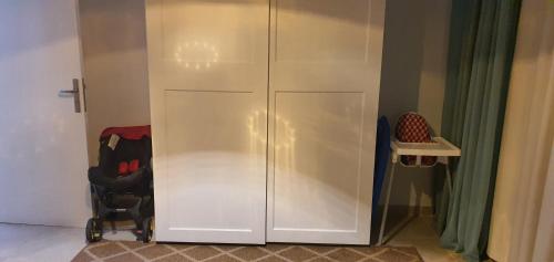 a white cabinet with two doors in a room at Soma Bay Ambiance - Relaxed Apartment - Next to The Breakers in Hurghada