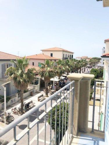 a balcony of a building with palm trees at Zì Maria in Marina di Cecina
