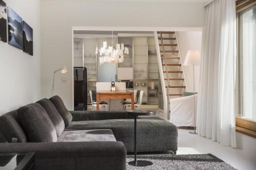 a living room with a couch and a table at Hallstatt Hideaway - Adults only in Hallstatt