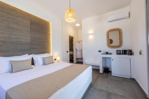 a bedroom with a large bed and a bathroom at Bonsai Luxury Suites in Karterados