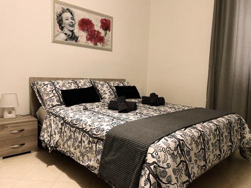 a bedroom with a bed with a black and white comforter at Dimora Nuscana in Nusco