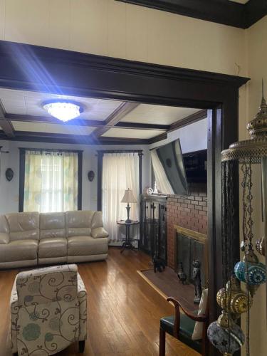 a living room with a couch and a fireplace at Elizabeth New Jersey bedroom -Newark Airport -New York City in Elizabeth