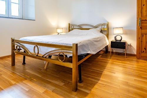 a bed in a room with a wooden floor at Pop Maison in Mendrisio