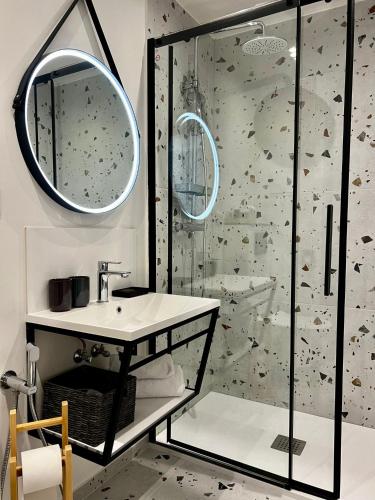 a bathroom with a shower and a sink and a mirror at Antik Hotel Prague in Prague