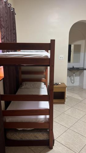 a couple of bunk beds in a room with a mirror at Canto do Casarão in Santos