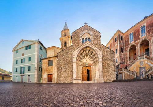 a large stone building with a church in a street at Casa verde in Ventimiglia