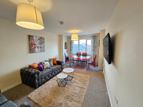 a living room with a couch and a table at 2 Bed Apt, 4 beds with Parking in Edinburgh