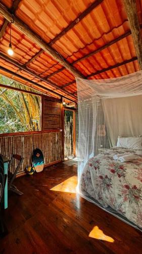 a bedroom with a bed and a wooden ceiling at Casa na Vila de Abraão in Abraão
