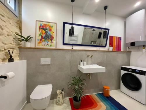 a bathroom with a sink and a washing machine at Studio 11 Bis in Vichy