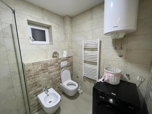 Un baño pequeño con inodoro y lavabo. en Casa Mia Apartments - Modern - Comfortable Stays 5 Min from Airport - Transport Possible, en Ledine