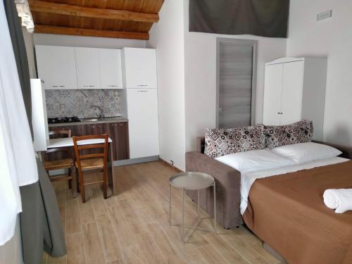 ein kleines Schlafzimmer mit einem Bett und einer Küche in der Unterkunft Casa Baglio Viole in Valderice