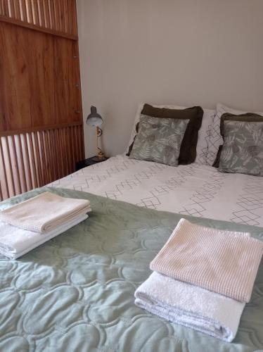 a bedroom with two beds with towels on them at Czwarte Piętro in Zamość