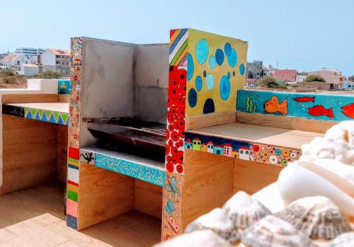 a colorful oven on top of a building at Casa Djarmai Boutique Apartments in Vila do Maio