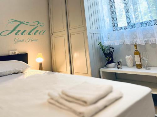a bedroom with a bed with two towels on it at Guest House Julia in Stavros