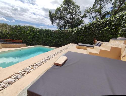 a pool with a table and a bench next to it at GKK House private swimming pool luxury house in Skriperón
