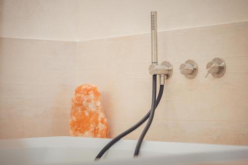 a doughnut hanging on a wall in a bath tub at Agriturismo La Pertica in Costermano sul Garda