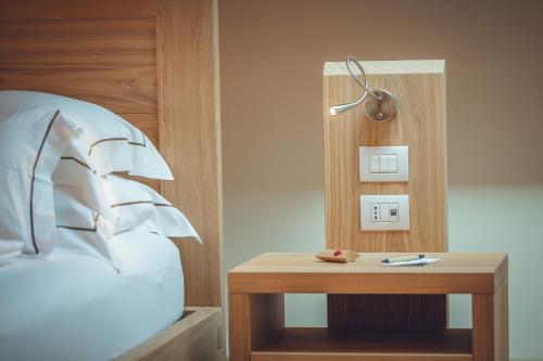 a bedroom with a bed and a table with a lamp at Agriturismo La Pertica in Costermano sul Garda