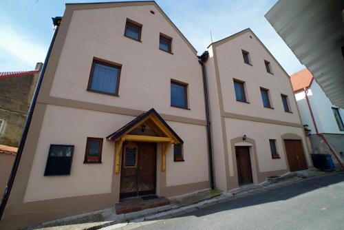 a two story building with a door on a street at Penzionu Aurelius u Bednářů in Pavlov