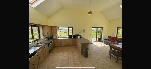 a large kitchen with a sink and a counter at Beautiful Home in Dingle in Dingle