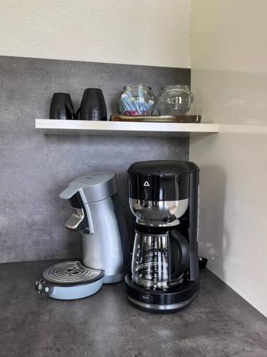 a coffee maker sitting on top of a counter at Appartement Le Domaine du Cygne in Barst-Marienthal