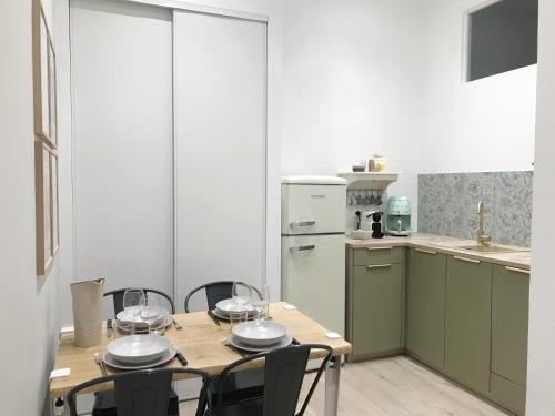 a kitchen with a wooden table with wine glasses on it at Casa verde in Ventimiglia