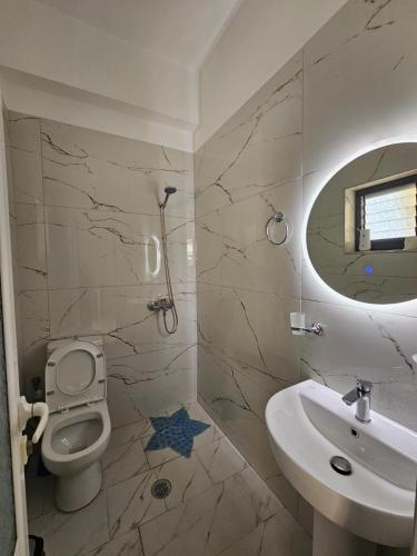 a bathroom with a toilet and a sink at DEA Room 1 in Sarandë