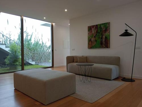 a living room with a couch and a table at Villa Amendoa in Arco da Calheta