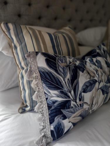 a blue and white pillow on a bed at Ing at Sandstone in Fouriesburg