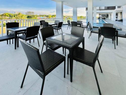 a group of tables and chairs on a patio at WV 6 Simple and Cozy in Iloilo City