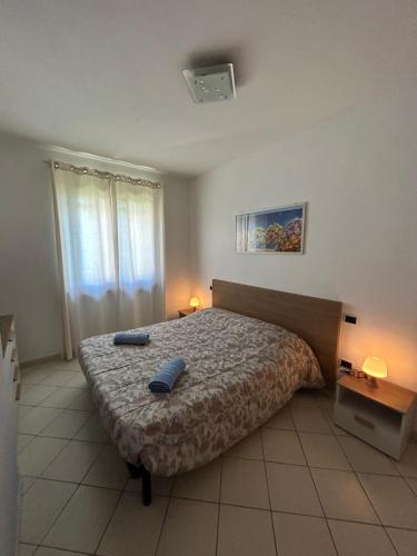 a bedroom with a bed with two blue towels on it at Consumella24 in Portoferraio