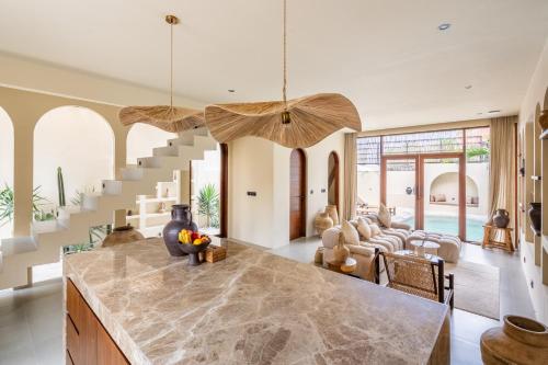 a kitchen with a staircase and a living room at Amani Villas: New, Luxury, Mediterranean, Private Pool, Canggu in Canggu