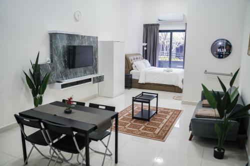 a living room with a dining table and a tv at KLIA AIRPORT HOMESTAY in Sepang
