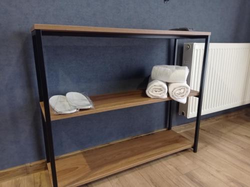 a shelf with towels on it in a room at Kazbegi 4U in Stepantsminda