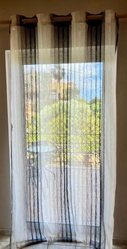 a curtain on a window in a room at Dream Apartments in Palaiochóra