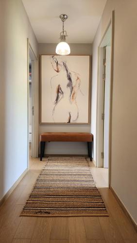 a hallway with a bench and a painting on the wall at Mountain View Suite at The Valley Khaoyai in Ban Huai Sok Noi