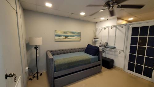 a bedroom with a bed in a room with a fan at BUNKER BEACH @ ISLA VERDE / Beach Front in San Juan