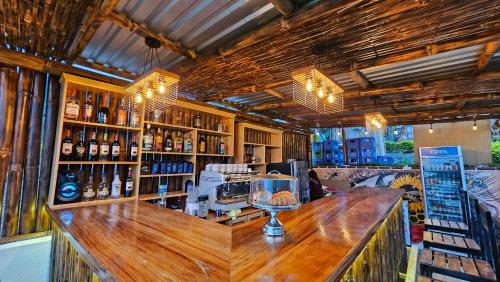 un bar con bancone in legno e bottiglie di vino di Glamping El Pájarero a San Juan La Laguna