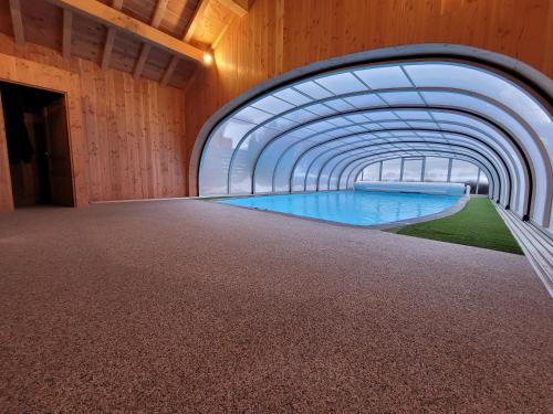 an external view of a swimming pool in a building at Julianna , appartements avec services gratuits in Morzine