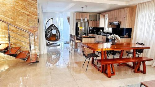 a kitchen with a wooden table and a dining room at Villa Sian in Punta Cana