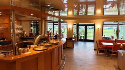 a restaurant with a counter with dishes on it at Hotel Strand-Café in Roßbach