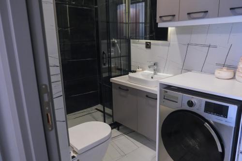 a bathroom with a toilet and a washing machine at No25 Suites Nisantasi in Istanbul