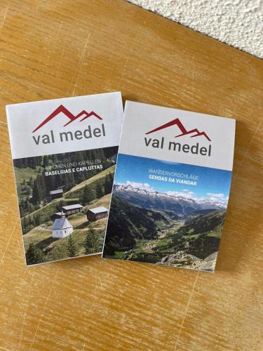 two brochures sitting on top of a table at Hospezi Santa Maria in Platta