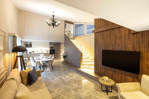 a living room with a couch and a tv at Nardi Nişantaşı in Istanbul